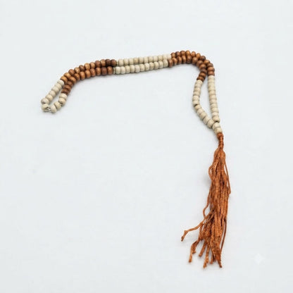 Two-tone brown and ivory wood tasbih prayer beads with gold spacers and orange-brown tassel