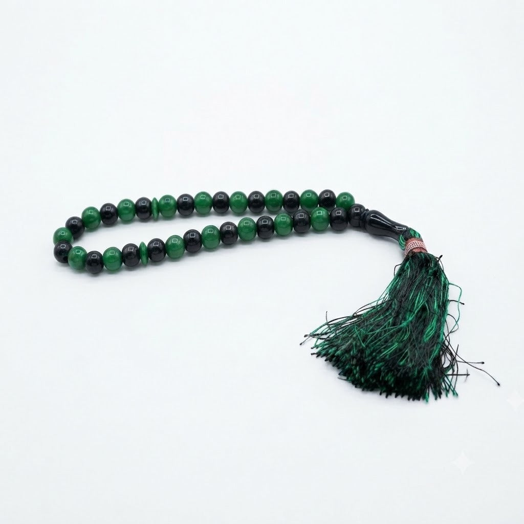 33-bead emerald green and black two-tone tasbih with rose gold accent ring and dark green tassel
