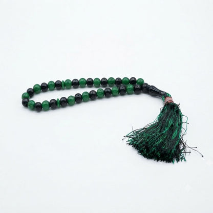 33-bead emerald green and black two-tone tasbih with rose gold accent ring and dark green tassel