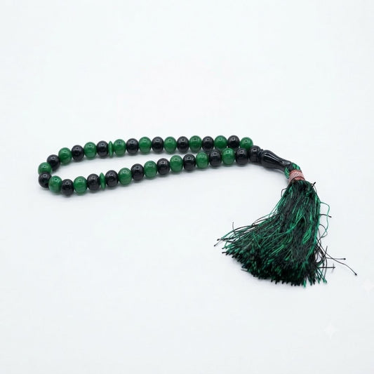 33-bead emerald green and black two-tone tasbih with rose gold accent ring and dark green tassel